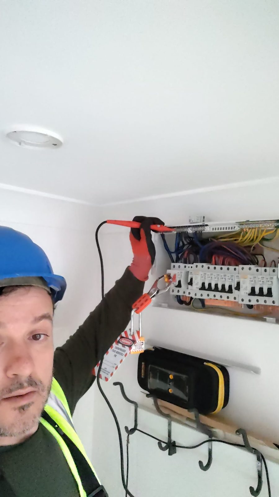 Sali from Kuka Electrical on site during a consumer unit upgrade with a lockout-tagout padlock fitted